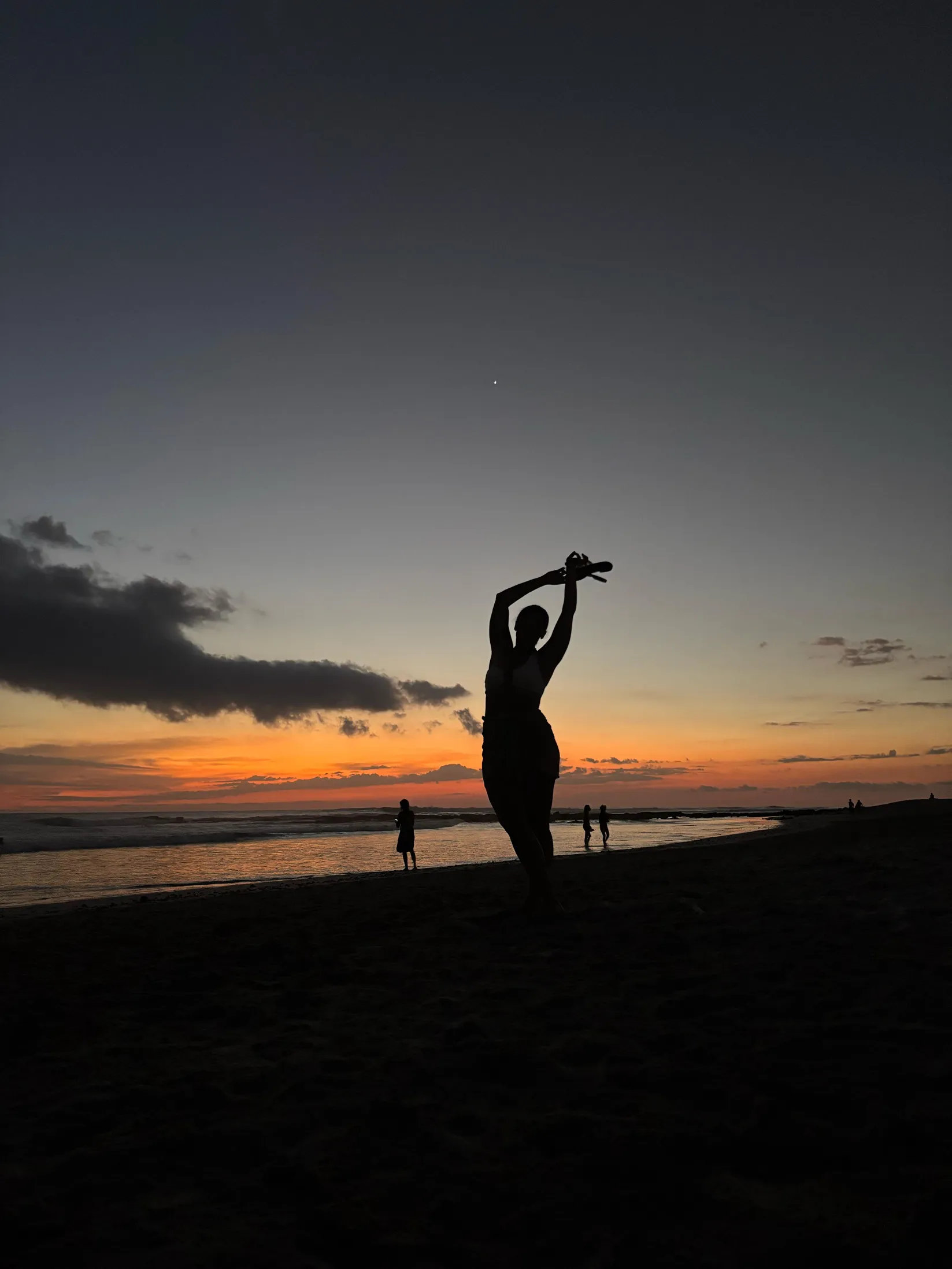 Stretching on the beach at sunset
